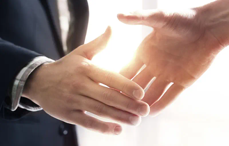 Two business people shaking hands.