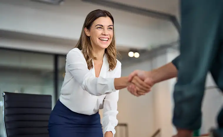 A business owner shaking hands with an agent.