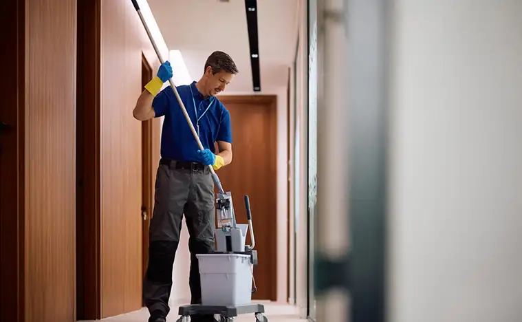 Common Area Maintenance Moping the hallway in an office building.