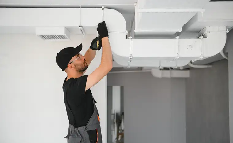 Preventive Maintenance Worker fixing the HVAC system.