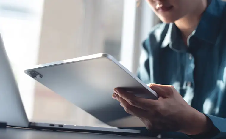 Business person looking at their tablet.