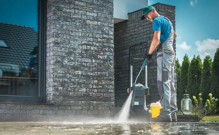 Maintenance worker cleaning the pavement.