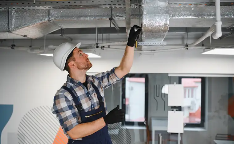 Maintenance worker fixing the HVAC system.